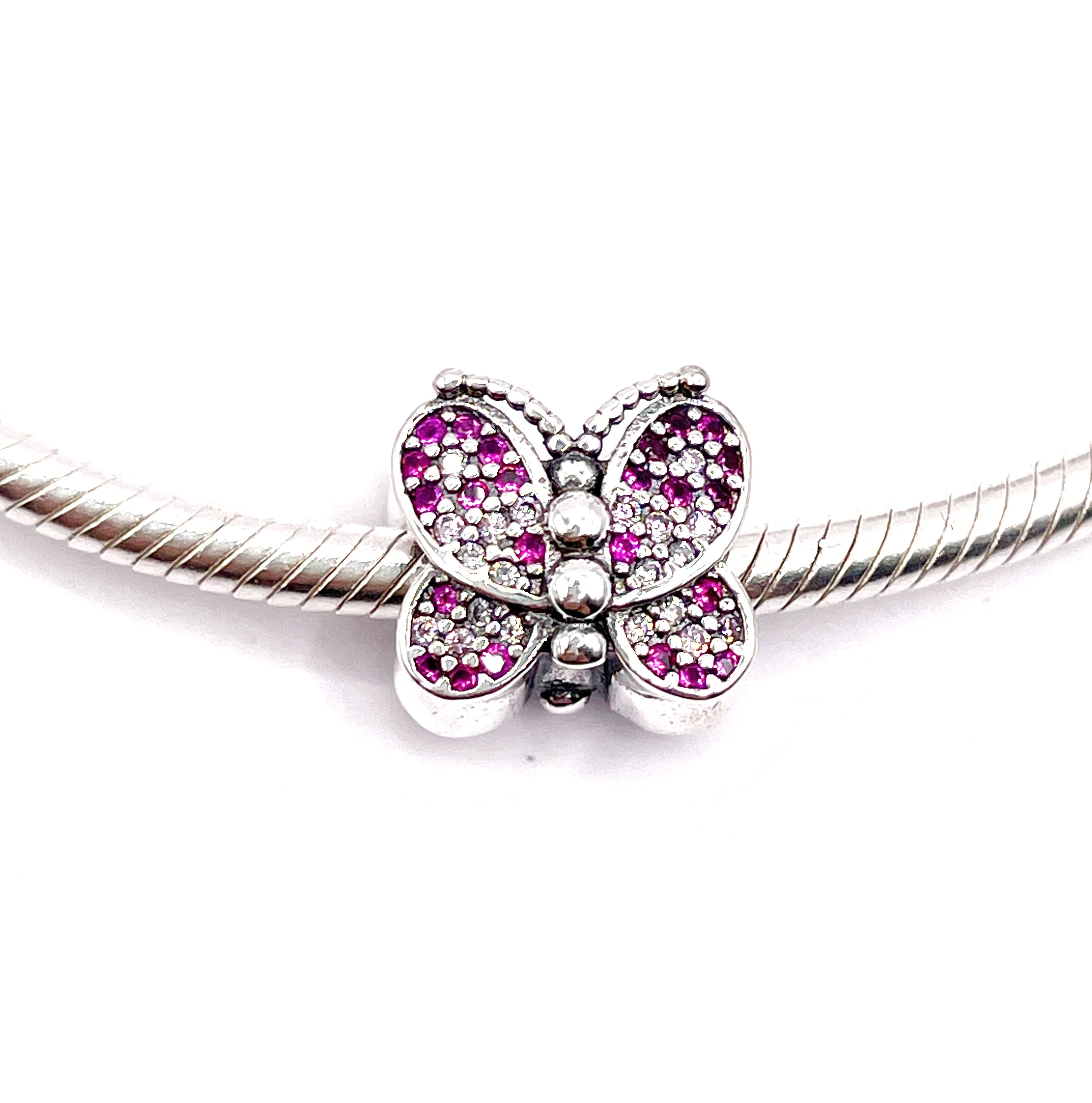 Charm Mariposa de circonias rosadas y fucsias